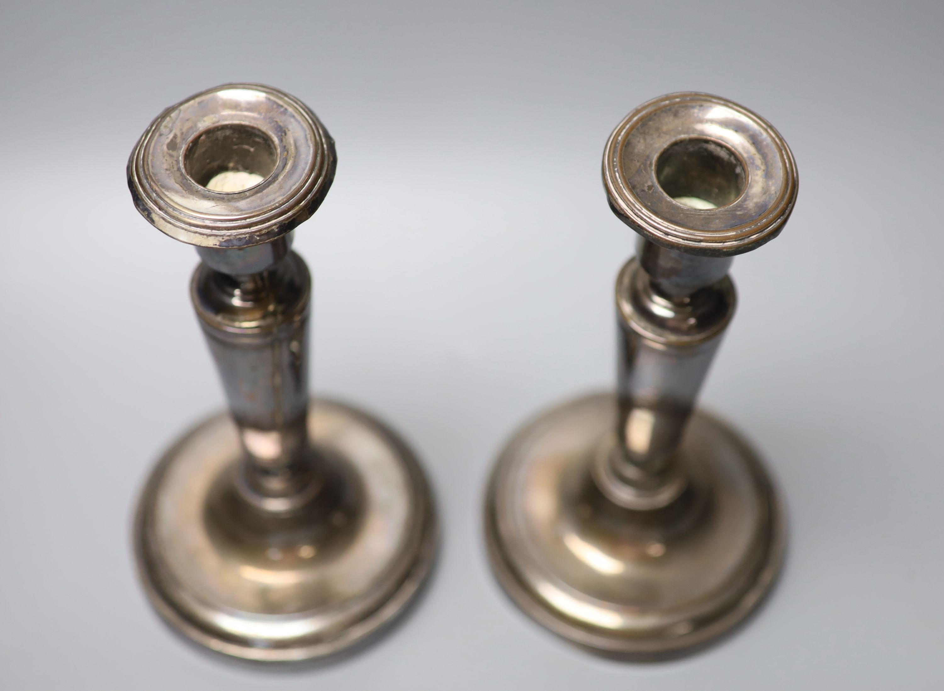 A pair of Austrian or Polish white metal candlesticks, height 20.8cm, gross 19.5oz.